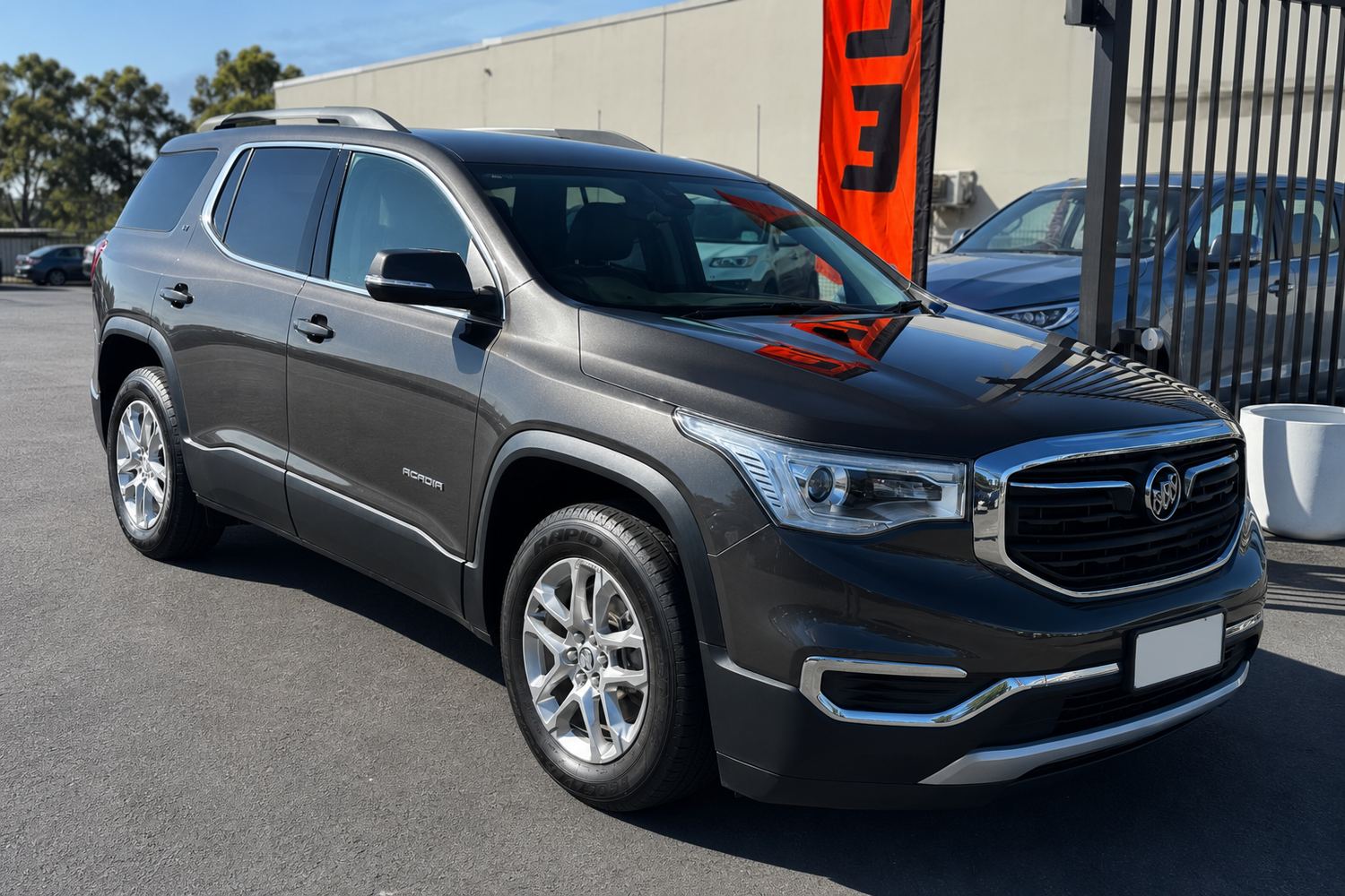 The same grey SUV after a full detail — glossy paint, spotless glass and clean wheels
